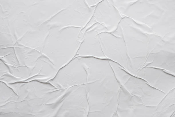 istock Blank white crumpled and creased paper poster texture background 1173165932