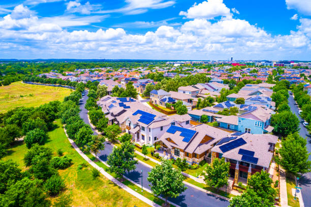 Help fight Climate Change and move into a Solar Panel Community in Austin Texas Solar Panel Community in Austin Texas Aerial drone view above Mueller District - energy efficiency and renewable energy focuses a sustainable living in East Austin Mueller District fighting climate change and global warming 2019 view high above suburb neighborhood solar panels on the roof of building in a city stock pictures, royalty-free photos & images