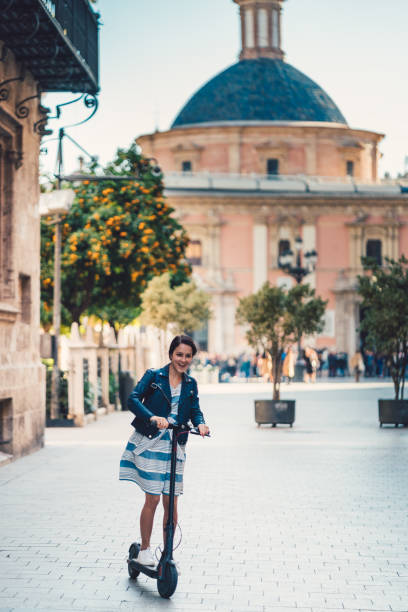 istock Woman riding scooter on her way to work 1173166088
