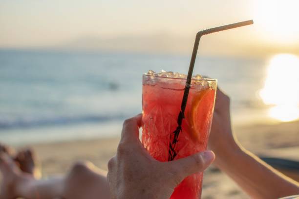 istock Person drinking cocktail at the beach.Holidays concept. 1173166506