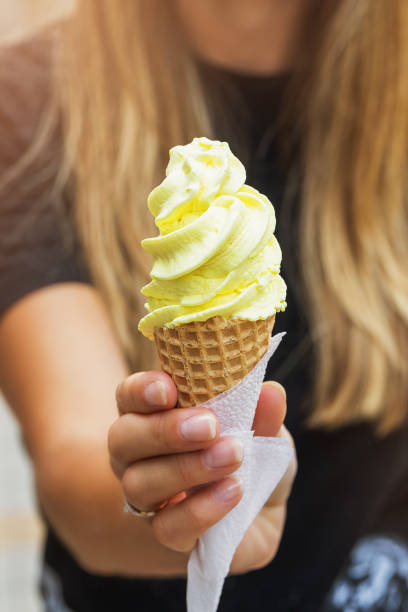 istock Girl holds a waffle cup with ice cream, close-up 1173167654