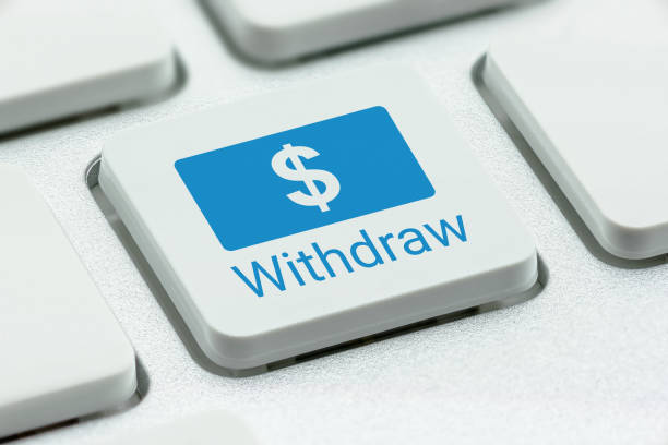 istock Microfinance, money borrowing / financial service concept : US dollar sign with a word Withdraw on a computer keyboard button, depicts small loan to poor clients to help them become self-sufficient 1173167966