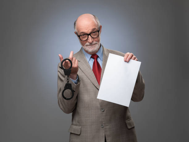 istock Business man with handcuffs and contract 1173168332