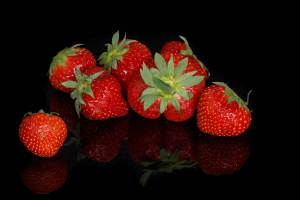 istock Fresh red ripe strawberries on a black background 1173174013