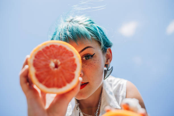 istock Charming young woman with grapefruit 1173175886