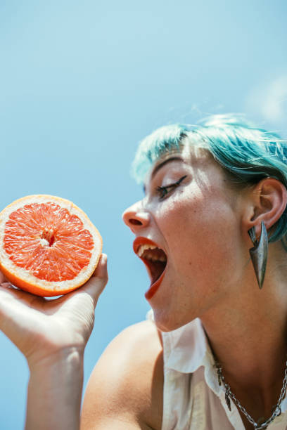 istock Charming young woman holding grapefruit 1173175912
