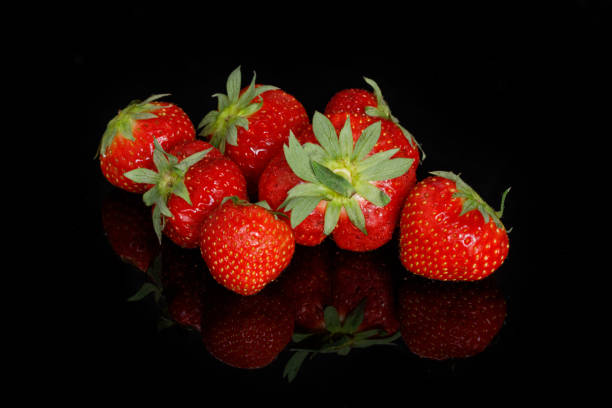 istock Fresh red ripe strawberries on a black background 1173176019