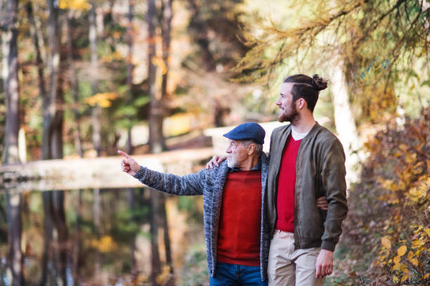 istock Senior father and his son walking in nature, talking. 1173177938