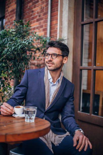 istock Stylish businessman drinking coffee 1173177963
