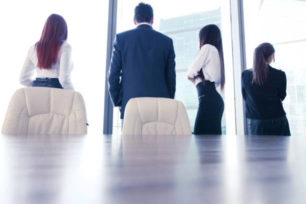 istock Business people looking at window 1173177967