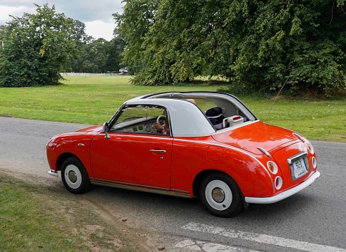 A 1992 Nissan Figaro, red front wheel drive,retro styled car in Dublin, Ireland. This model first manufactured in 1991.