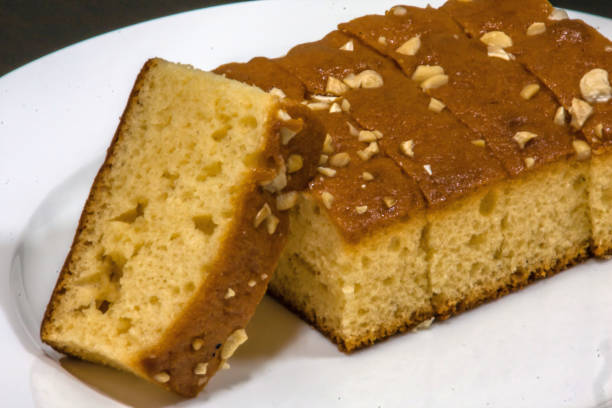 istock A cut cake with cashew on a white plate 1173181727