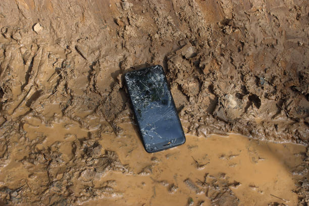 istock A broken smartphone lies on a dirty surface. The touch screen is cracked and damaged. 1173183250