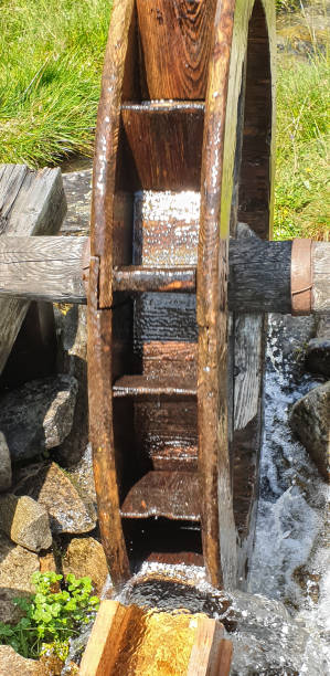 istock Spinning wooden water wheel at work 1173184384