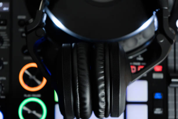 istock Professional dj headphones on audio mixer controller.Big black headset on sound mixing panel.Audio equipment for disc jockey 1173185456