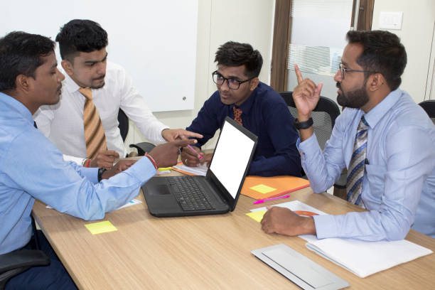 istock Business team pointing at blank laptop screen 1173185899