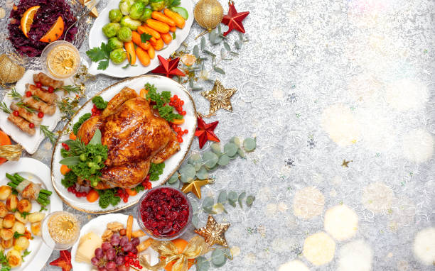 Concept of Christmas or New Year dinner with roasted chicken and various vegetables dishes Concept of Christmas or New Year dinner with roasted chicken and various vegetables dishes. Top view. sauces table turkey christmas stock pictures, royalty-free photos & images