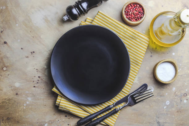 istock Plate and yellow cotton napkin on beige background. 1173186824