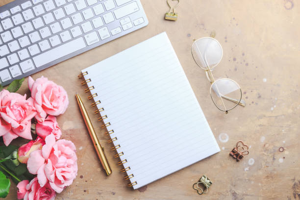 istock Office desk with computer and rose flowers 1173186854