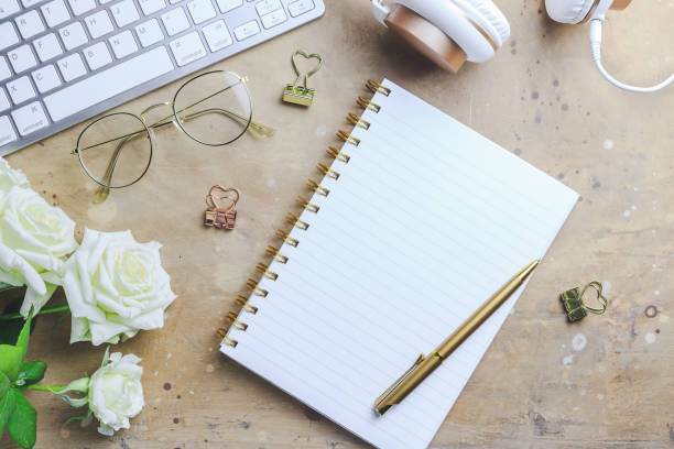istock Office desk with computer and rose flowers 1173186889