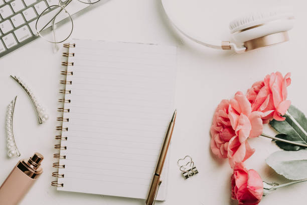 istock Office desk with computer and rose flowers 1173186890