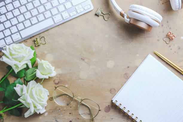 office desk with computer and rose flowers - spiral notebook audio imagens e fotografias de stock
