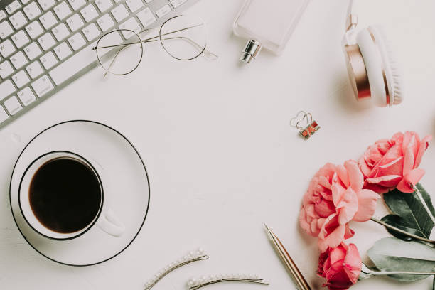 istock Office desk with computer and rose flowers 1173186954