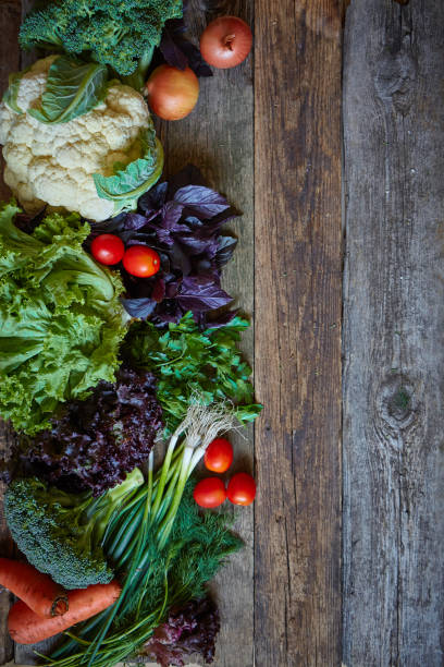 istock Fresh vegetables and herbs on an old rough wooden surface, healthy eating concept, selective focus 1173187326