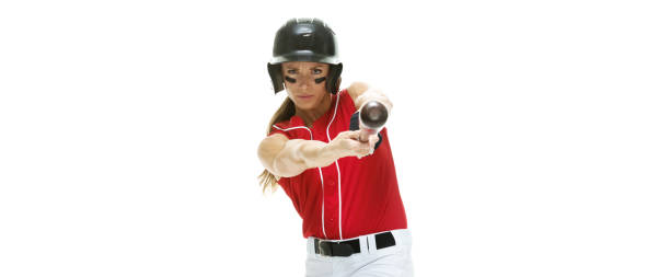 waist up / side view / profile view / looking at camera of 20-29 years old adult beautiful brown hair / long hair caucasian female / young women athlete / baseball player / softball player standing in a sports league in front of white background - 20 25 years profile female young adult imagens e fotografias de stock