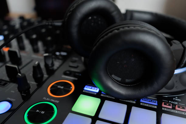 istock Professional dj headphones on audio mixer controller.Big black headset on sound mixing panel.Audio equipment for disc jockey 1173189063