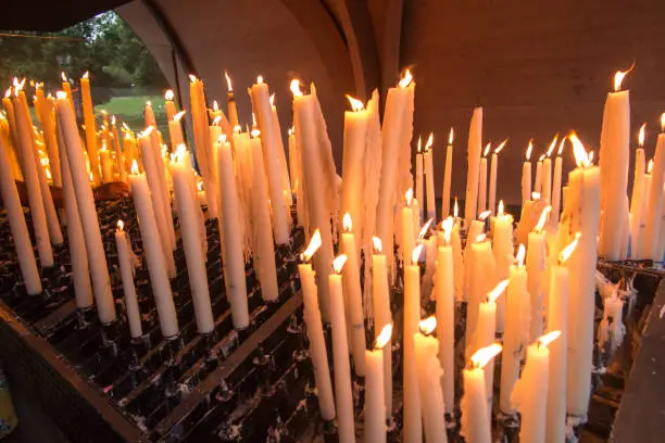 Photo of lit candles at the Marian shrine in Lourdes