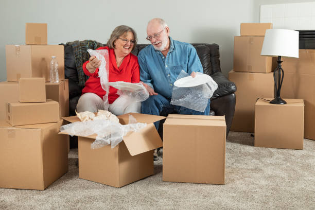 istock Senior Adult Couple Packing or Unpacking Moving Boxes 1173190085