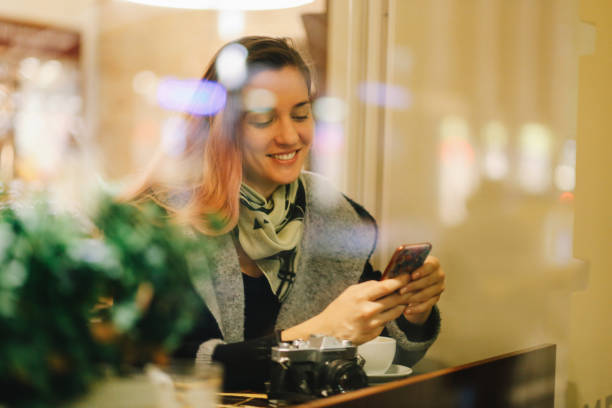 istock Young woman in a Berlin cafe texting on the smartphone 1173190440
