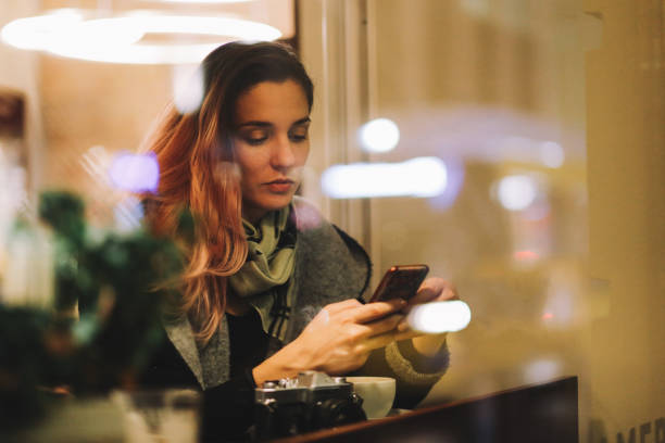 istock Young woman in a Berlin cafe texting on the smartphone 1173190509