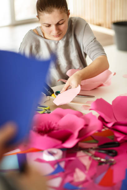 istock Making paper flowers and using glue gun at the workstation 1173191005