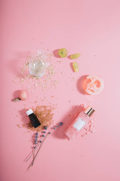 istock Creative flat lay top view bottles mock up and vase on pastel millennial pink paper background copy space. Template for text lettering blogging 1173192477