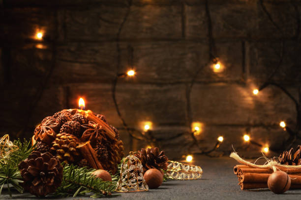 istock Christmas composition - decorative candle, Christmas tree branches and decorations on a dark background with blurry lights 1173195473