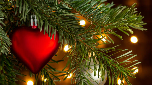 istock Christmas composition, ball and other decorations on the branches of a Christmas tree on a dark background with lights 1173195504