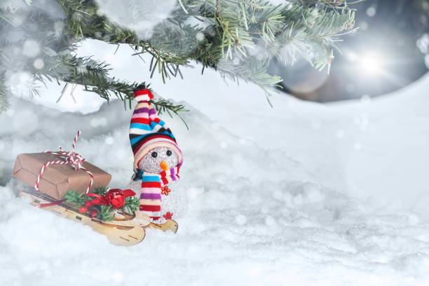istock Christmas composition under the Christmas tree - a snowman, boxes with gifts on a sled, place for text, copy space 1173195529