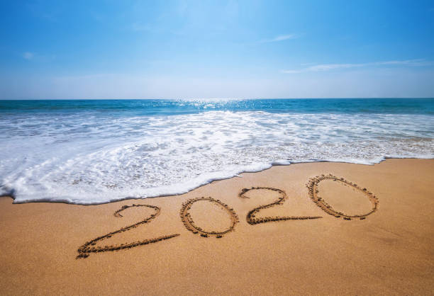 happy new year 2020 is coming concept sandy tropical ocean beach lettering. exotic new year celebration concept image. - horizon over water environment vacations nature imagens e fotografias de stock