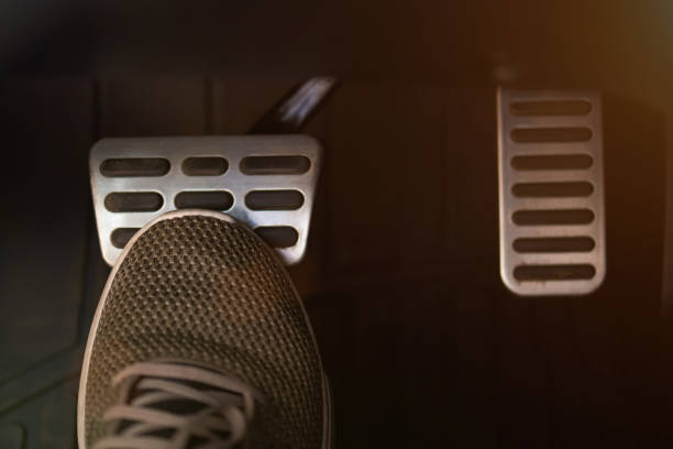 Pressing break pedal Pressing break car pedal  with shoe close up view brake stock pictures, royalty-free photos & images