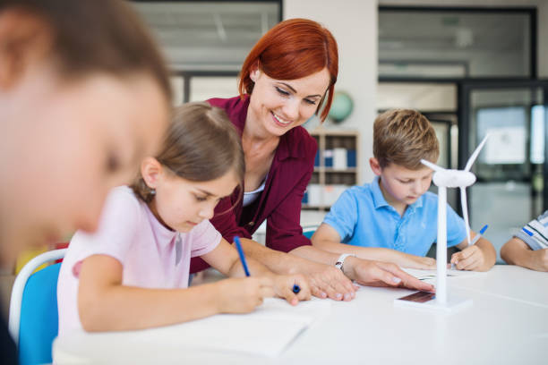 istock A group of small school kids with teacher in class learning about environment. 1173199018