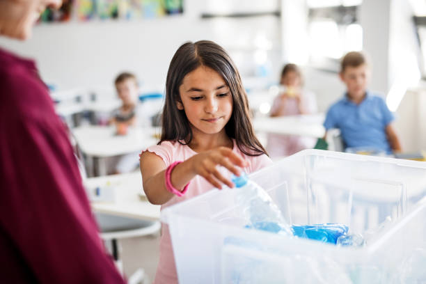 istock A teacher with small school kids in classroom learning about waste separation. 1173199100