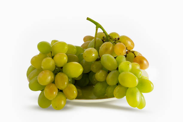 istock Brush green grapes lying on a plate, close-up. Isolated on white background. 1173199232