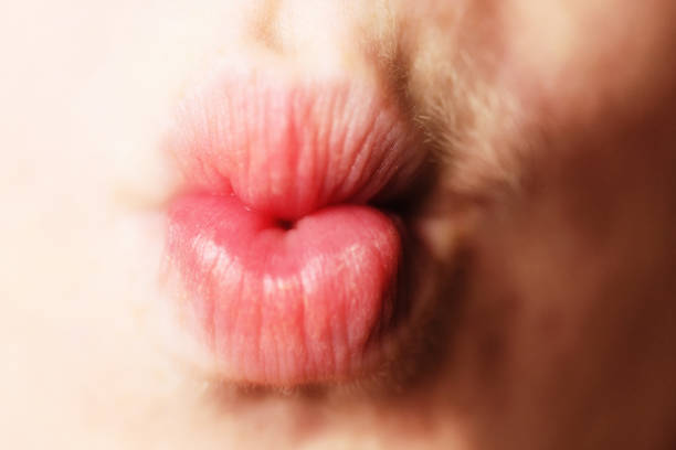 Beautiful woman lips in a heart formed by abstract blots