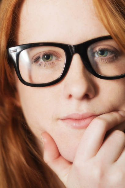istock Confident young red-headed woman looks at the camera 1173203131