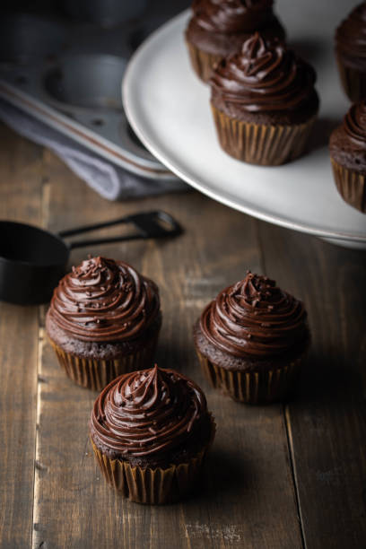 istock chocolate cupcake on dark wooden background 1173204561