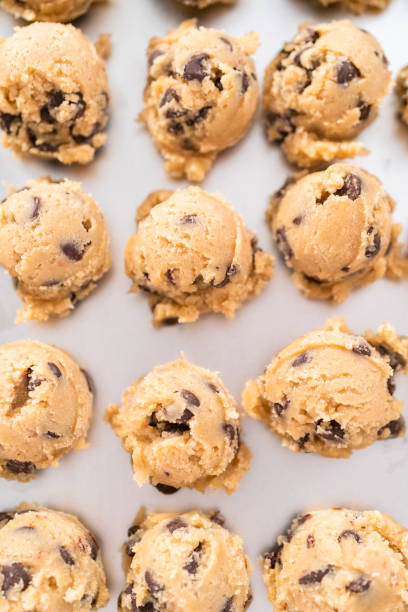 istock Homemade chocolate chip cookies dough scoops on a baking sheet. 1173205592