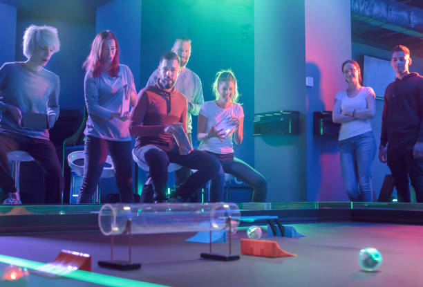 istock Friends playing with Infrared Ball Chasing Robot at amusement arcade 1173208846