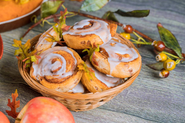 istock Homemade cinnamon rolls with white glaze and apple. 1173209132